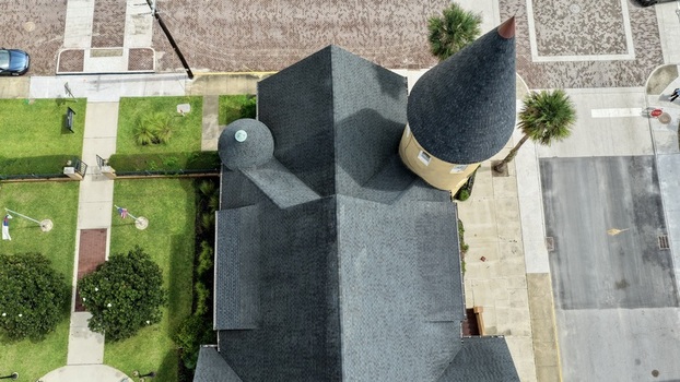 Aerial view of Ancient City Baptist Church with its distinctive conical tower and dark shingled roof surrounded by green lawns and paved streets in St. Augustine Florida United States. Aerial view of Ancient City Baptist Church with its distinctive conical tower and dark shingled roof surrounded by green lawns and paved streets in St. Augustine Florida United States.