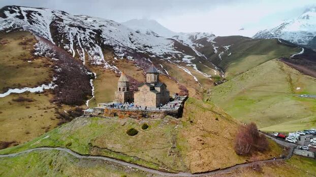 Aerial view of Gergeti Trinity Church on a mountain ridge Georgia.