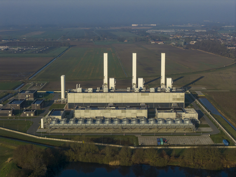 Aerial view of the Nitrogen plant featuring tall white chimneys and industrial cooling systems surrounded by flat agricultural fields in Zuidbroek Groningen Netherlands. Aerial view of the Nitrogen plant featuring tall white chimneys and industrial cooling systems surrounded by flat agricultural fields in Zuidbroek Groningen Netherlands.