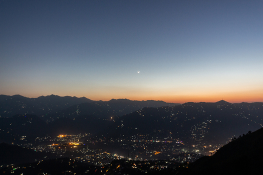 View of a city nestled between mountains with lights twinkling as twilight paints the sky in pastel hues creating a serene atmosphere Muzaffarabad Azad Kashmir Pakistan. View of a city nestled between mountains with lights twinkling as twilight paints the sky in pastel hues creating a serene atmosphere Muzaffarabad Azad Kashmir Pakistan.