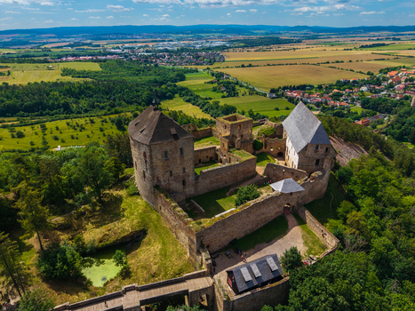Aerial view of Tocnik Castle featuring stone walls historic ruins and surrounding lush green forests and fields in Tocnik Stredocesky kraj Czechia. Aerial view of Tocnik Castle featuring stone walls historic ruins and surrounding lush green forests and fields in Tocnik Stredocesky kraj Czechia.