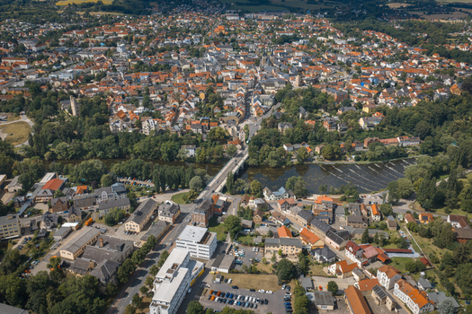 Aerial view of the historic town of Saalfeld with dense urban layout red tiled rooftops and a bridge crossing the river surrounded by trees in Saalfeld Thuringia Germany. Aerial view of the historic town of Saalfeld with dense urban layout red tiled rooftops and a bridge crossing the river surrounded by trees in Saalfeld Thuringia Germany.
