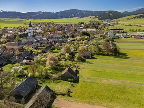 Aerial view of the historic village of Partizanska Lupca featuring the St. Matthew s Church tower traditional architecture and green fields in Partizanska Lupca Zilina Region Slovakia.