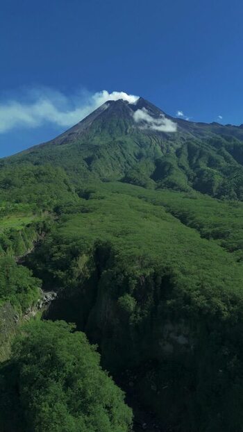 Aerial view of Mount Merapi with smoking peak and slopes Indonesia.