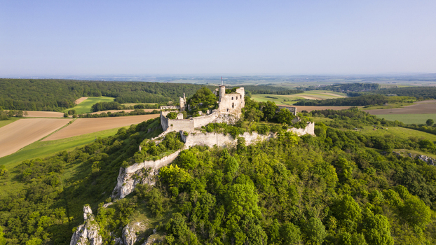 Aerial view of the weathered Falkenstein Castle ruins a testament to history atop a verdant tree covered hill Falkenstein Lower Austria Austria. Aerial view of the weathered Falkenstein Castle ruins a testament to history atop a verdant tree covered hill Falkenstein Lower Austria Austria.