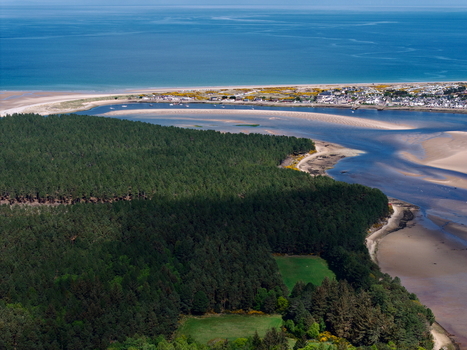 Aerial view of Findhorn Bay with dense pine forest sandy beaches and the coastal village Findhorn Scotland United Kingdom. Aerial view of Findhorn Bay with dense pine forest sandy beaches and the coastal village Findhorn Scotland United Kingdom.