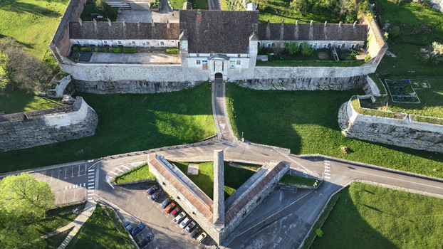 Aerial view of the historic Besancon Citadel featuring stone fortifications tiled roofs and green moats in Besancon Bourgogne Franche Comte France. Aerial view of the historic Besancon Citadel featuring stone fortifications tiled roofs and green moats in Besancon Bourgogne Franche Comte France.