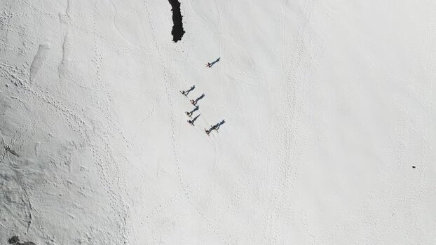 Aerial view of people walking on snow near Rifugio Sapienza Italy. Aerial view of people walking on snow near Rifugio Sapienza Italy.