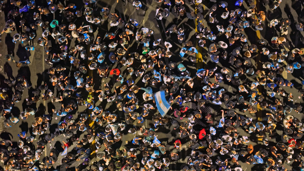 Buenos Aires Argentina 15 July 2026 Aerial view of a large crowd of soccer fans celebrating in the streets at night waving Argentine flags after a FIFA World Cup semifinal match. Buenos Aires Argentina 15 July 2026 Aerial view of a large crowd of soccer fans celebrating in the streets at night waving Argentine flags after a FIFA World Cup semifinal match.