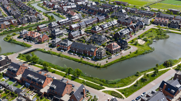 Aerial view of a modern residential neighborhood with brick houses winding canals and green spaces in Utrecht Utrecht Netherlands. Aerial view of a modern residential neighborhood with brick houses winding canals and green spaces in Utrecht Utrecht Netherlands.