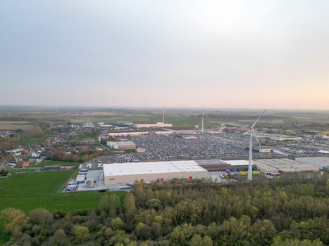 Aerial view of a vast industrial landscape dotted with wind turbines contrasting the pale structures against the surrounding verdant fields Ath Wallonia Belgium. Aerial view of a vast industrial landscape dotted with wind turbines contrasting the pale structures against the surrounding verdant fields Ath Wallonia Belgium.