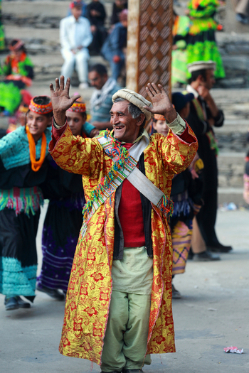 Chitral Khyber Pakhtunkhwa Pakistan 14 May 2013 View of a man in traditional Kalash clothing dancing with his hands raised during a cultural festival in Rumbur.