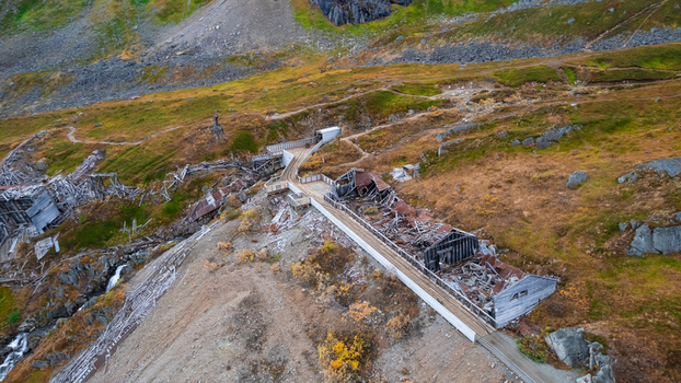 Aerial view of Independence Mine State Historical Park featuring historic wooden mining structures rusted ruins and mountain trails in Palmer Alaska United States.