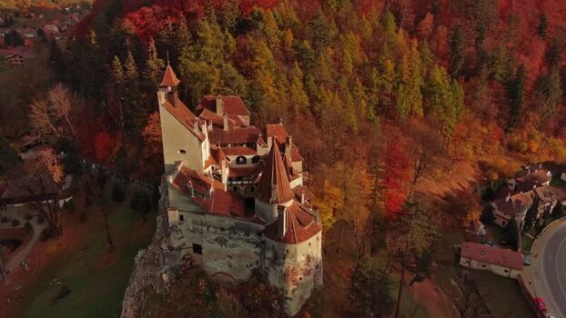 Aerial view of Bran Castle surrounded by autumn forest in Romania. Aerial view of Bran Castle surrounded by autumn forest in Romania.