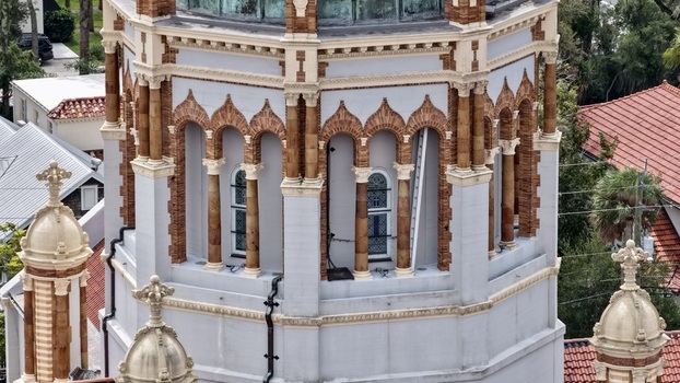 Aerial view of the ornate dome and architectural details of the Memorial Presbyterian Church featuring intricate brickwork and arched windows in St. Augustine Florida United States.
