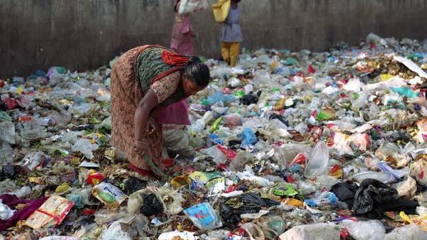 View of people sorting plastic waste at a landfill Bangladesh. View of people sorting plastic waste at a landfill Bangladesh.