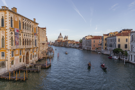 Venice Veneto Italy 21 September 2026 View of the Grand Canal with gondolas navigating the water and the Santa Maria della Salute basilica in the distance under a clear sky. Venice Veneto Italy 21 September 2026 View of the Grand Canal with gondolas navigating the water and the Santa Maria della Salute basilica in the distance under a clear sky.