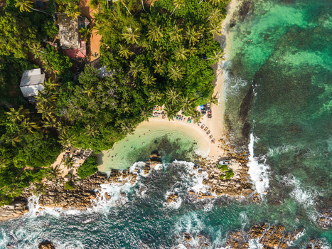 Aerial view of Secret Beach Mirissa with turquoise waters rocky coastline and dense palm trees Mirissa Southern Province Sri Lanka. Aerial view of Secret Beach Mirissa with turquoise waters rocky coastline and dense palm trees Mirissa Southern Province Sri Lanka.