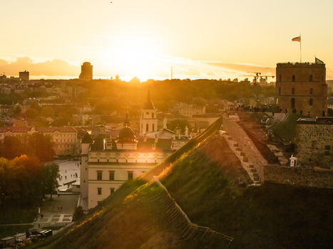 Aerial view of Gediminas Tower stands proudly against the golden sunset with the Cathedral Square and Palace of the Grand Dukes casting long shadows Vilnius Lithuania. Aerial view of Gediminas Tower stands proudly against the golden sunset with the Cathedral Square and Palace of the Grand Dukes casting long shadows Vilnius Lithuania.