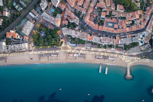 Aerial view of the coastline with sandy beaches turquoise Mediterranean sea and urban architecture including residential buildings and streets in Cannes Provence Alpes Cote d Azur France. Aerial view of the coastline with sandy beaches turquoise Mediterranean sea and urban architecture including residential buildings and streets in Cannes Provence Alpes Cote d Azur France.