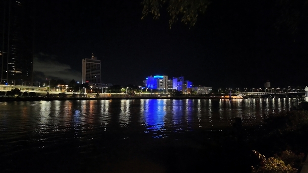 View of the illuminated Brisbane city skyline reflecting on the Brisbane River at night in Brisbane Queensland Australia. View of the illuminated Brisbane city skyline reflecting on the Brisbane River at night in Brisbane Queensland Australia.