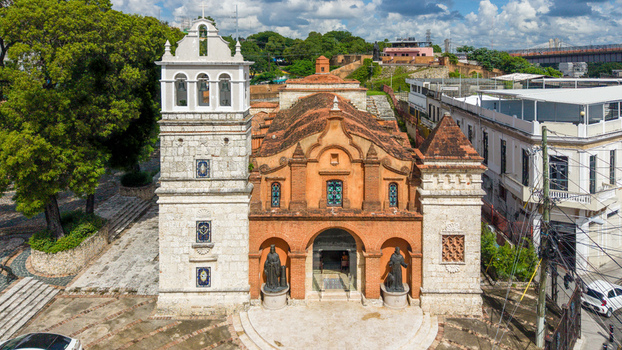 Aerial view of the historic Catedral Castrense de Santa Barbara with its orange brick facade and stone bell tower in Santo Domingo Distrito Nacional Dominican Republic. Aerial view of the historic Catedral Castrense de Santa Barbara with its orange brick facade and stone bell tower in Santo Domingo Distrito Nacional Dominican Republic.