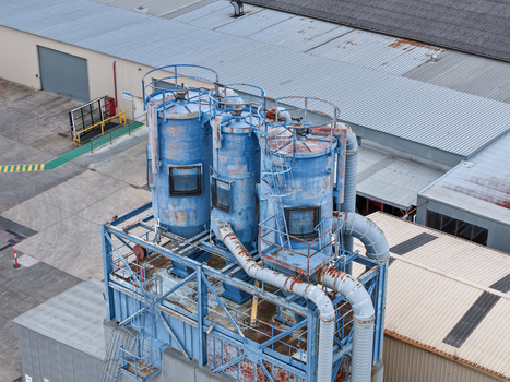 Melbourne VIC Australia 25 September 2026 Aerial view of industrial blue silos and metal piping systems at a manufacturing facility.