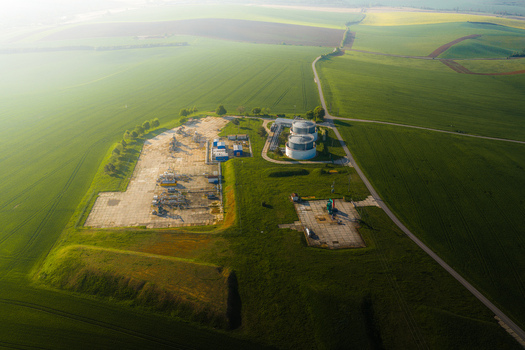 Aerial view of UGS Damborice gas storage facility with industrial tanks and technical structures surrounded by green agricultural fields in Damborice South Moravian Region Czechia. Aerial view of UGS Damborice gas storage facility with industrial tanks and technical structures surrounded by green agricultural fields in Damborice South Moravian Region Czechia.