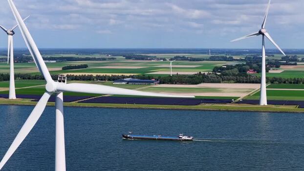 Aerial view of wind turbines and a barge in Rutten Netherlands.
