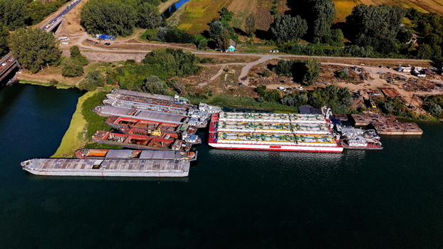 Aerial view of cargo barges and industrial vessels docked at the Smederevo shipyard along the Danube River in Smederevo Podunavlje District Serbia. Aerial view of cargo barges and industrial vessels docked at the Smederevo shipyard along the Danube River in Smederevo Podunavlje District Serbia.