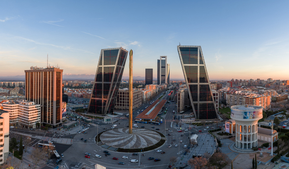 Aerial view of the iconic Puerta de Europa leaning towers and the Obelisk of Caja Madrid at Plaza Castilla during sunset in Madrid Comunidad de Madrid Spain.