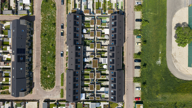 Aerial view of Ecodorp Zuiderveld featuring modern sustainable housing with solar panels and green roofs in Nijmegen Gelderland Netherlands. Aerial view of Ecodorp Zuiderveld featuring modern sustainable housing with solar panels and green roofs in Nijmegen Gelderland Netherlands.
