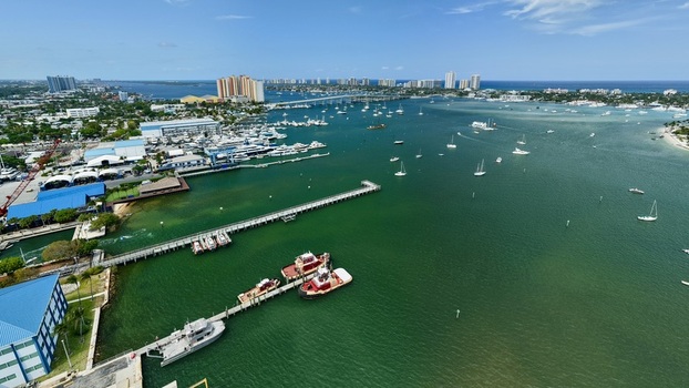 Aerial view of Peanut Island and the Lake Worth Lagoon with numerous boats and yachts docked at the marina in Palm Beach County Florida United States.