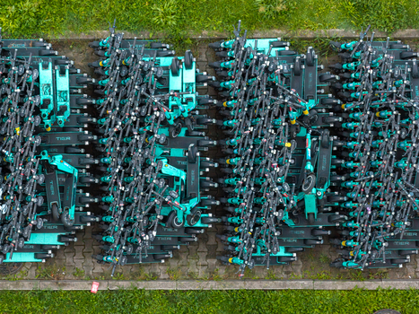 Warsaw Poland 21 August 2026 Aerial view of a large fleet of teal electric scooters neatly parked in rows on a paved area surrounded by green grass. Warsaw Poland 21 August 2026 Aerial view of a large fleet of teal electric scooters neatly parked in rows on a paved area surrounded by green grass.