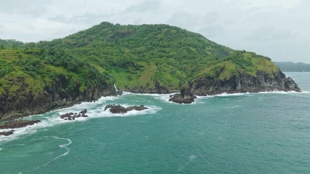 Aerial view of Banyutibo Water Fall and rocky cliffs Indonesia.
