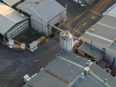 Melbourne VIC Australia 22 September 2026 Aerial view of industrial factory buildings with metal roofs storage tanks and pallets in a paved yard in Kilsyth. Melbourne VIC Australia 22 September 2026 Aerial view of industrial factory buildings with metal roofs storage tanks and pallets in a paved yard in Kilsyth.
