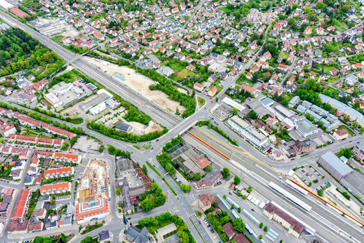 Aerial view of the Bahnhofstrasse area featuring railway tracks residential houses and lush green trees in Forchheim Bayern Germany. Aerial view of the Bahnhofstrasse area featuring railway tracks residential houses and lush green trees in Forchheim Bayern Germany.