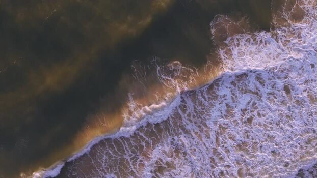 Aerial view of waves at Lyngvig Fyr Strand Denmark.
