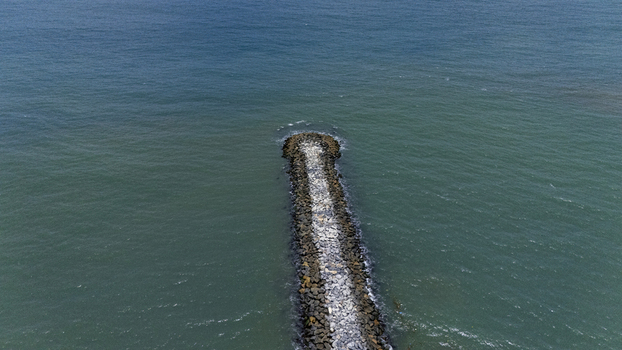 Aerial view of a stone breakwater extending into the turquoise ocean waters near Lekki Beach Road Lekki Lagos Nigeria. Aerial view of a stone breakwater extending into the turquoise ocean waters near Lekki Beach Road Lekki Lagos Nigeria.