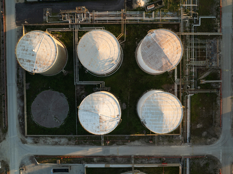 Aerial view of industrial storage tanks and a complex network of pipelines at a refinery facility in Augusta Sicily Italy. Aerial view of industrial storage tanks and a complex network of pipelines at a refinery facility in Augusta Sicily Italy.