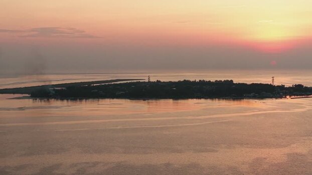Aerial view of Kudahuvadhoo island at sunset Maldives. Aerial view of Kudahuvadhoo island at sunset Maldives.