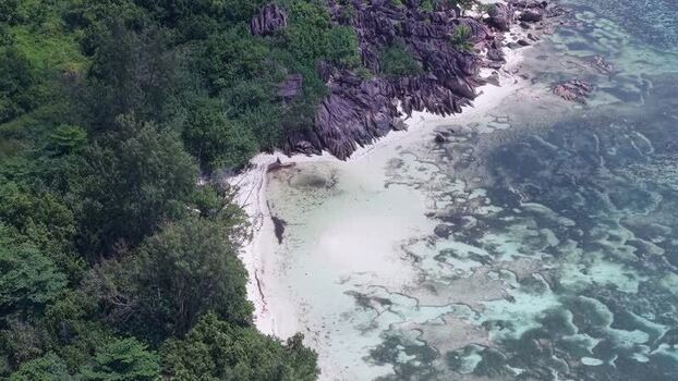 Aerial view of Curieuse island beach with granite rocks Seychelles.