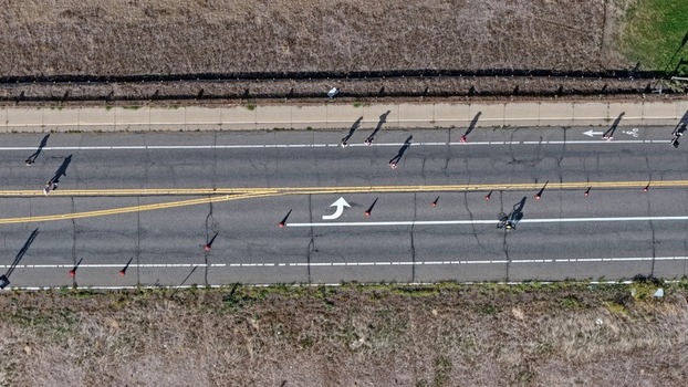 Aerial view of runners and pedestrians on a road with traffic cones and lane markings in Boulder Colorado United States. Aerial view of runners and pedestrians on a road with traffic cones and lane markings in Boulder Colorado United States.