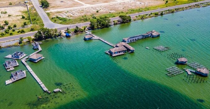 Aerial view of stilt houses and wooden walkways over green water in Ghana. Aerial view of stilt houses and wooden walkways over green water in Ghana.