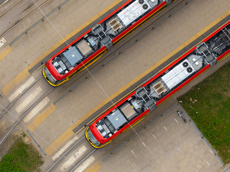 Aerial view of two red and yellow trams parked at the tram depot in Warsaw Masovian Voivodeship Poland. Aerial view of two red and yellow trams parked at the tram depot in Warsaw Masovian Voivodeship Poland.