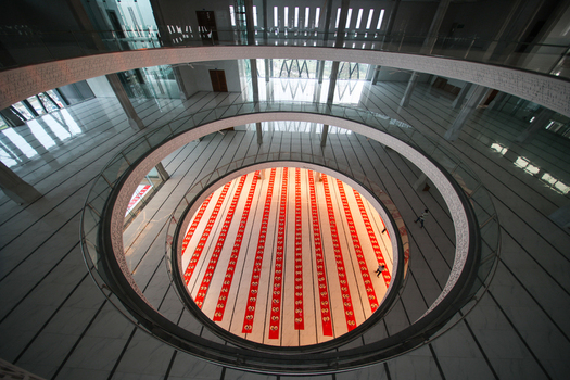 Aerial view of the Baitul Mukarram National Mosque interior with rows of red prayer mats Dhaka Dhaka Division Bangladesh. Aerial view of the Baitul Mukarram National Mosque interior with rows of red prayer mats Dhaka Dhaka Division Bangladesh.