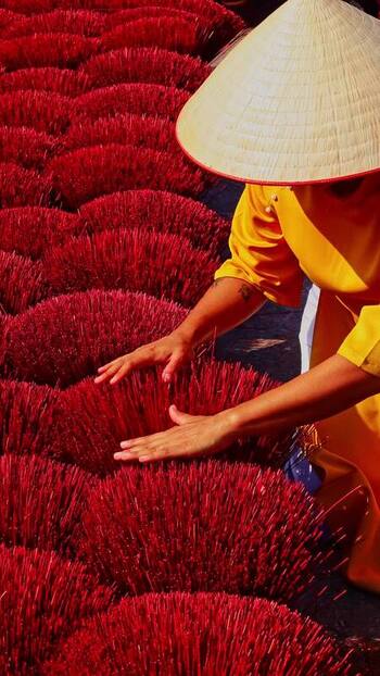 View of a person with red incense sticks Vietnam.