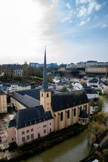 Aerial view of Neumunster Abbey situated along the Alzette River in the historic Grund district featuring its distinctive spire and stone architecture in Luxembourg Luxembourg Luxembourg.