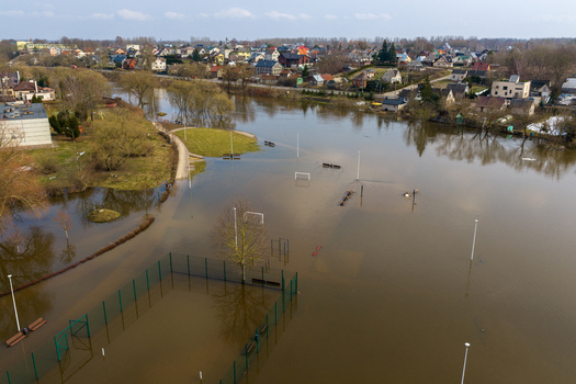 Aerial view of a flooded sports field and park with submerged football goals and fences near residential houses in Kedainiai Kaunas County Lithuania. Aerial view of a flooded sports field and park with submerged football goals and fences near residential houses in Kedainiai Kaunas County Lithuania.