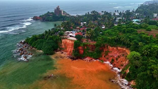 Aerial view of coastal cliffs and lush vegetation in Sri Lanka.
